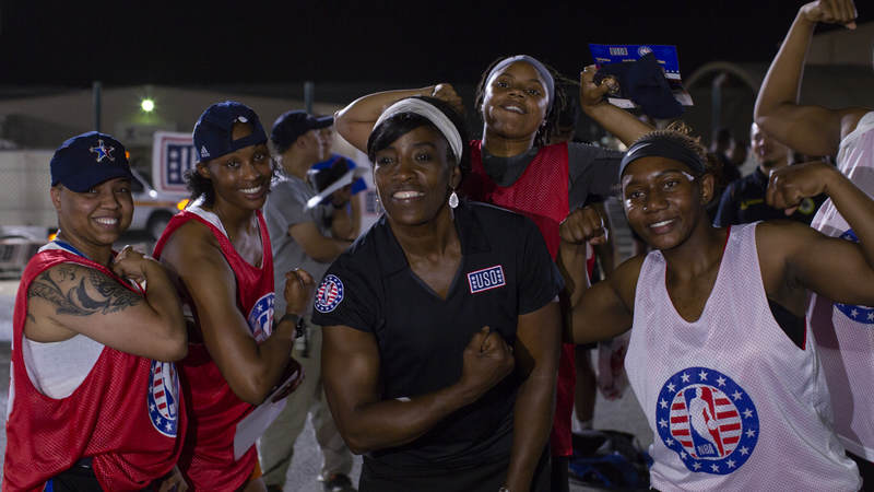 Ruthie Bolton smiles with service members.