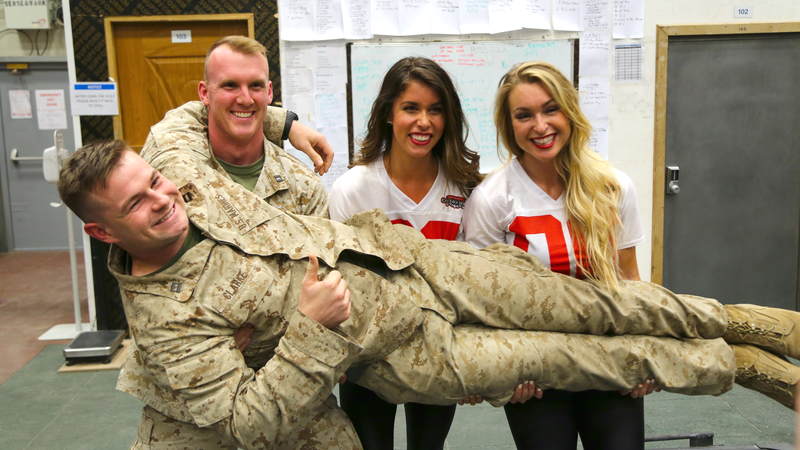 Cheeleaders Brianna Stade, right, and Alexandria Giannini have some fun with service members during their USO tour to Iraq and Kuwait.