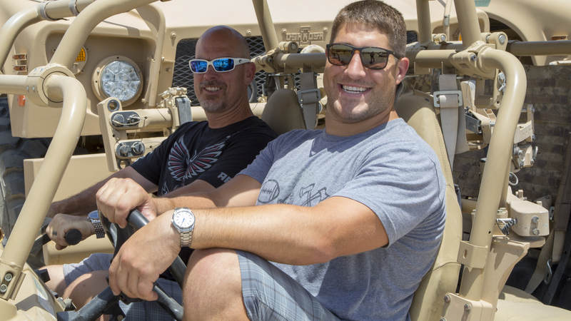 Falcons players Matt Bryant, left, and Alex Mack are ready to go off-roading in a military vehicle during their USO tour to Iraq and Kuwait.