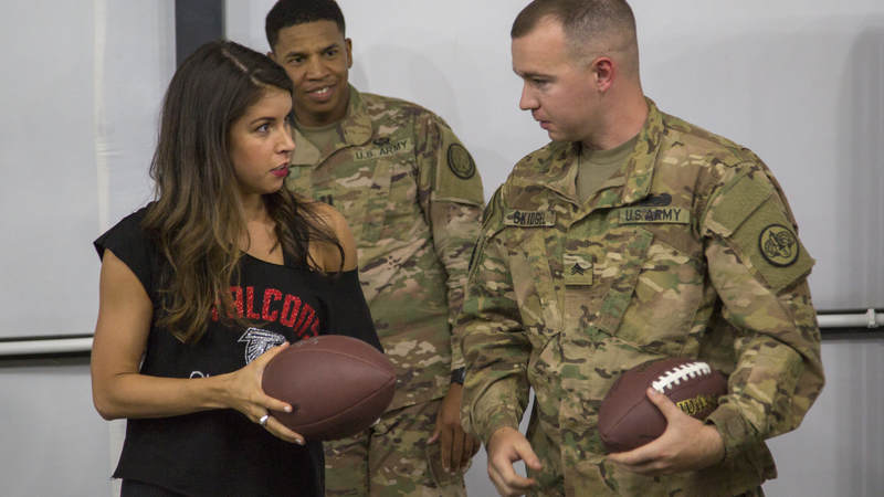 Falcons cheerleader Alexandria Giannini chats with a service member during a meet-and-greet session during the tour.