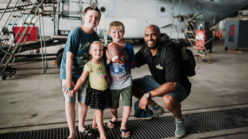 Former New York Giants star Amani Toomer spends time with some young NFL fans during the USO-NFL Legends tour to Okinawa, Japan, on July 25-26. USO photos by Amber Craig
