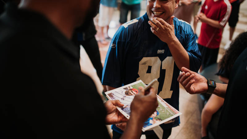 Amani Toomer signs an autograph for one of his biggest fans during the USO-NFL Legends tour to Okinawa, Japan, on July 25-26. USO photos by Amber Craig