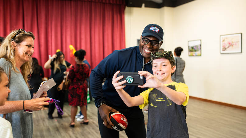 Former NFL star Tony Richardson, who played most of his 16-year NFL career with the Kansas City Chiefs, poses for a photo with a young fan during the USO-NFL Legends tour to Okinawa, Japan, on July 25-26. USO photos by Amber Craig