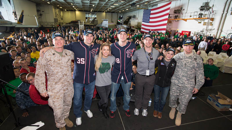 Members of the 2012 USO Holiday Tour, Craig Stammen, Kellie Pickler, Ross Detwiler, Matt Hendricks and Iliza Shlesinger, pose for a quick photo onboard the USS John C. Stennis.