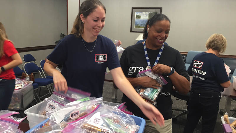 USO South Carolina staff and volunteers package and load care packages for service members providing hurricane relief along the east coast.