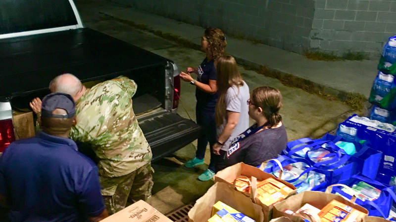 USO South Carolina staff and volunteers package and load care packages for service members providing hurricane relief along the east coast.