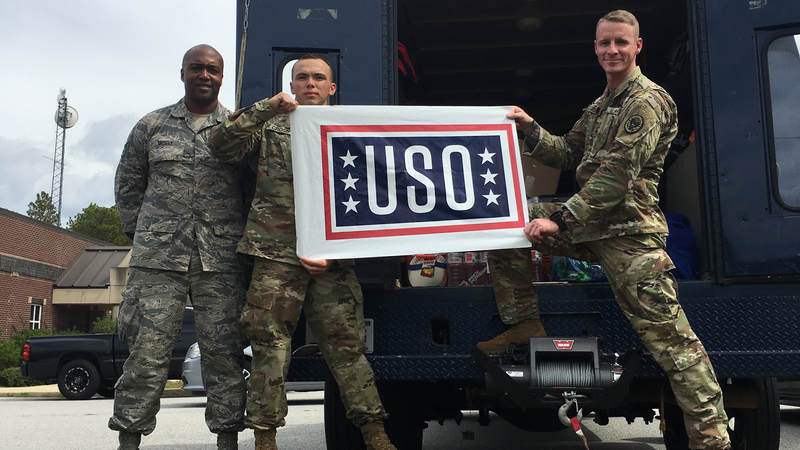 Members of the South Carolina National Guard volunteer with the USO to help prepare care packages for service members supporting hurricane relief efforts.