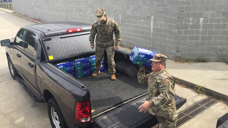 Members of the South Carolina National Guard volunteer with the USO to help prepare care packages for service members supporting hurricane relief efforts.