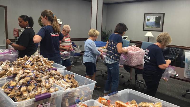 USO South Carolina staff and volunteers package and load care packages for service members providing hurricane relief along the east coast.