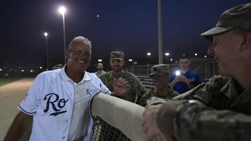 Former Kansas City Royals third baseman and designated hitter George Brett, who played for the Royals for 21 years, spends time with service members at a pickup softball game. USO Photo by Neal Preston