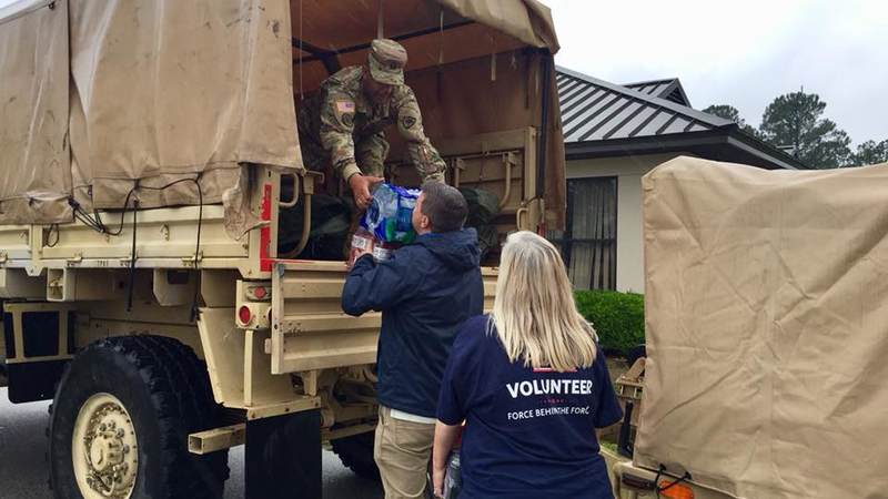 Members of the South Carolina National Guard volunteer with the USO to help prepare care packages for service members supporting hurricane relief efforts.