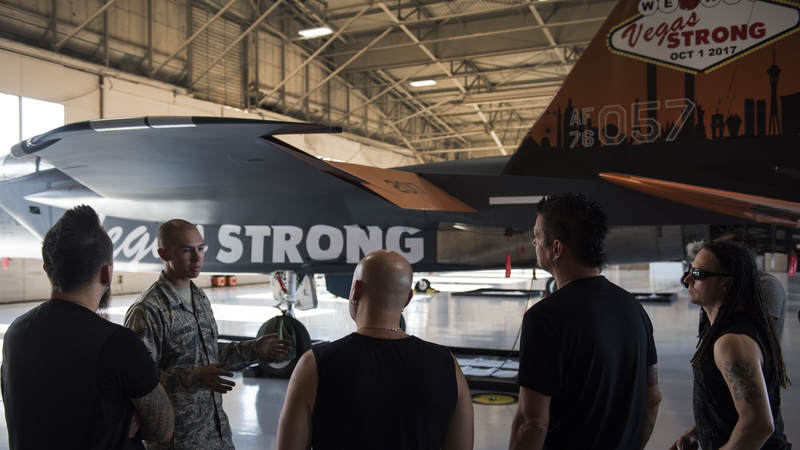 Members of the band Disturbed tour the 57th Wing Eagle Aircraft Maintenance Unit at Nellis Air Force Base, Nevada, October 24.