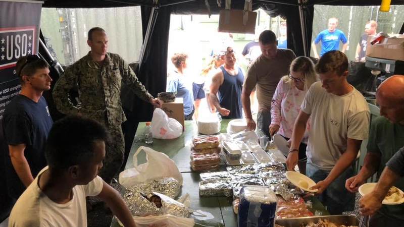 Service members deployed to Tinian for Typhoon Yutu enjoy a Thanksgiving meal, courtesy of the USO.