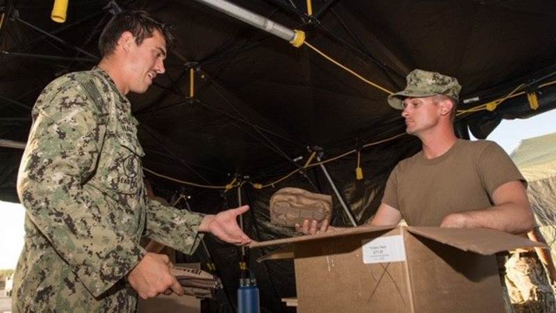 Service members receive USO Care Packages while deployed to Saipan and Tinian for Typhoon Yutu relief efforts.