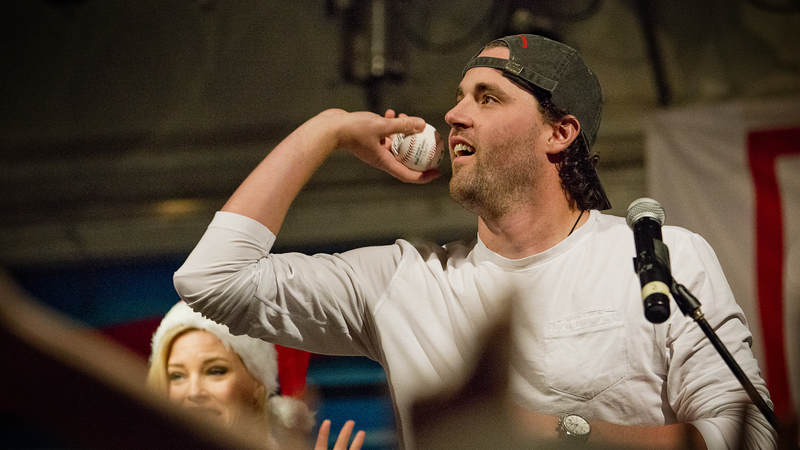 Heath Hembree throws out souvenir baseballs to the audience.
