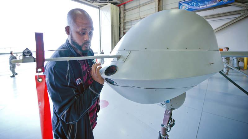 Sydney Castillo checks out a MQ-1 "Predator," a remotely piloted aircraft.