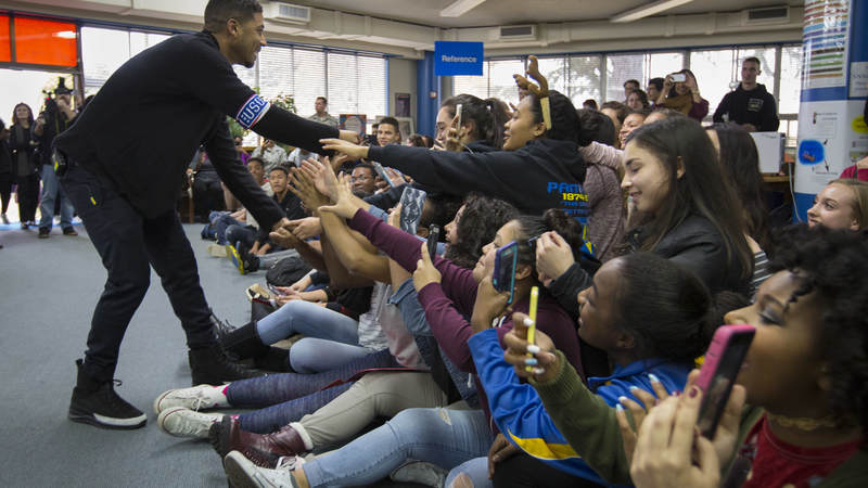 Jussie Smollett greets students at Yokota High School during a USO tour to Japan.