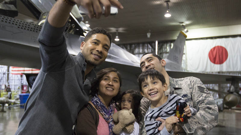 Jussie Smollett takes a selfie with a military family during the "Empire" USO tour to Japan.