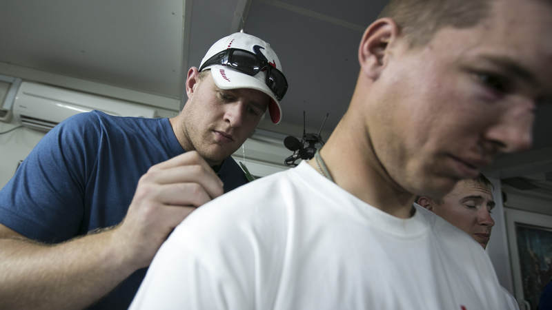Houston Texans defensive end J.J. Watt autographs a shirt for an injured soldier stationed in the Middle East during a 2013 USO/NFL tour.