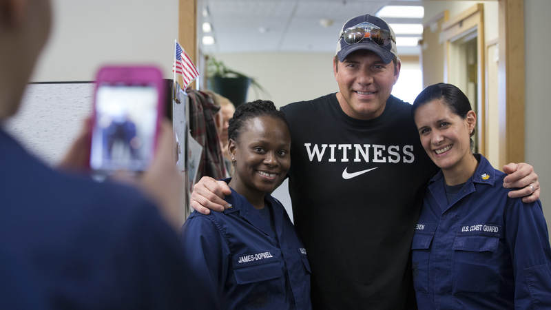 Country musician Rodney Atkins poses for a photo with service members at Coast Guard Air Station Kodiak, Alaska, on September 17.