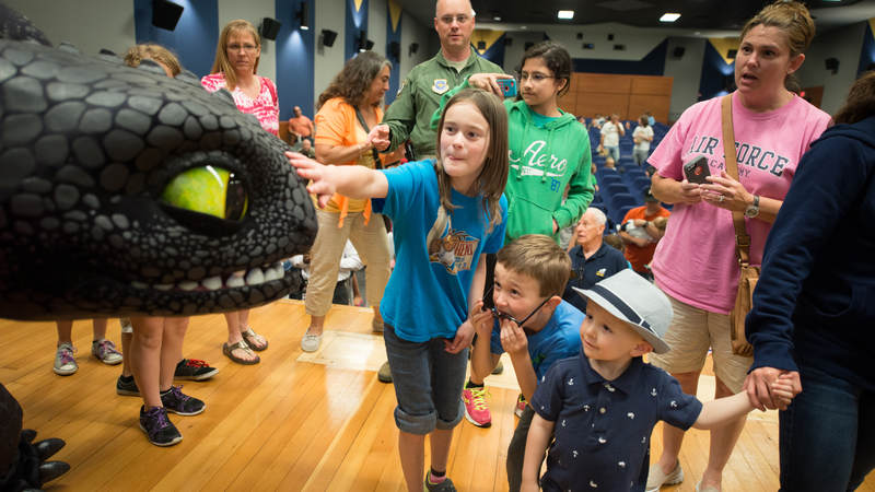 Military personnel and their families get to meet with "Toothless" the dragon following a special advance USO screening of the movie "How to Train Your Dragon 2," at Joint Base McGuire-Dix-Lakehurst, New Jersey, in 2014.