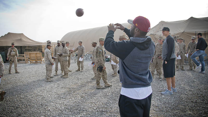 Pierre Garcon, of the Washington Redskins, plays catch with service members stationed in the Middle East in 2014.
