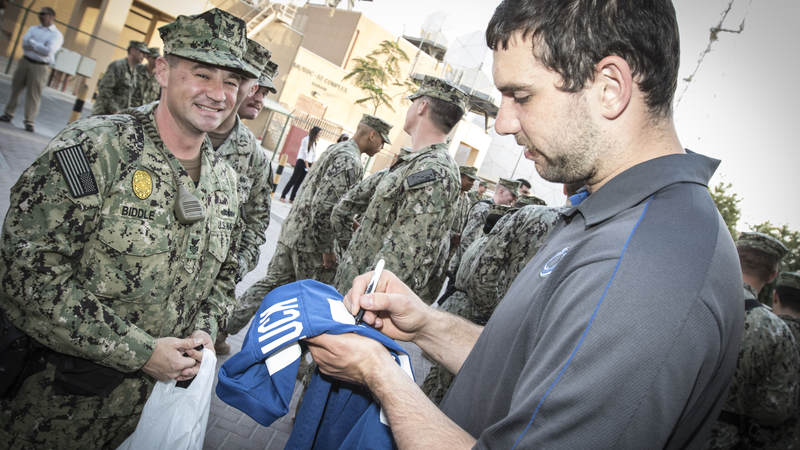 Andrew Luck signs a shirt for a sailor at Naval Support Activities Bahrain during a 2015 tour.