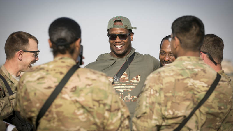 Denver Broncos linebacker Von Miller visits with troops stationed in the Middle East during a stop on his weeklong USO/NFL tour in 2013.