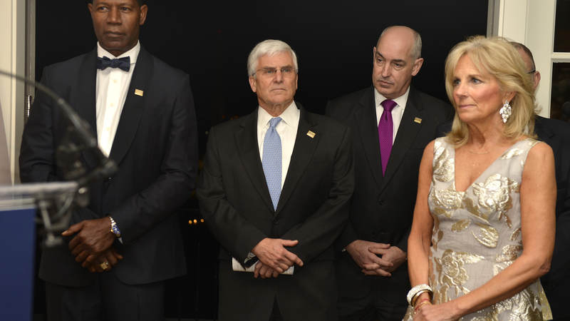 Actor Dennis Haysbert, Chairman of the USO Board of Governors Retired Army Gen. George W. Casey, Jr., USO CEO and President J.D. Crouch II and Dr. Jill Biden listen to speeches.