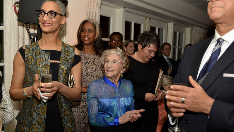 Carla Hall, chef and co-host of ABC's "The Chew," and artist Lila Asher, also a WWII-era USO volunteer, listen to speeches.