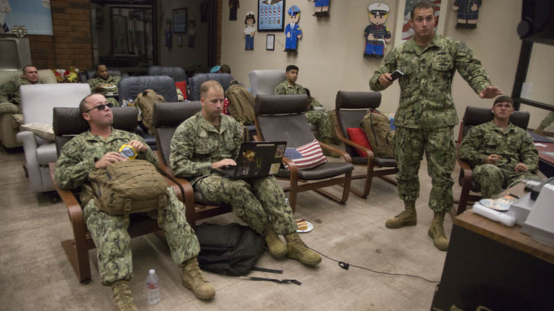 Navy Seabees relax in the entertainment room of USO Ontario on Feb. 8 during a short, late-night layover.