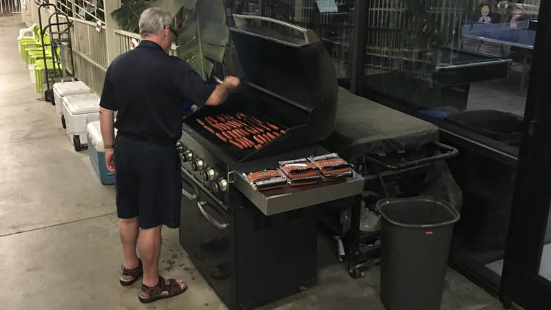 USO Ontario volunteer cooks hot dogs for Navy Seabees at 1 a.m. Feb. 8.