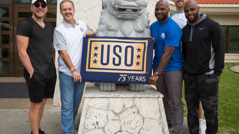 Coach Pagano (second left), McAfee (left), Jackson (third right), Anthony Castonzo (second right) and Adams (right) pose for a photo with a Shisa during a USO tour stop at Camp Foster in Okinawa, Japan, on Feb. 19.